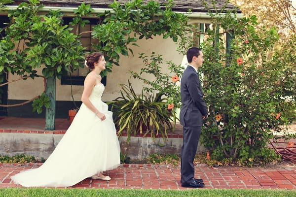 Bride walking up behind groom