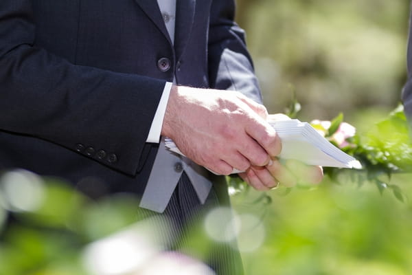 Man holding wedding order of service