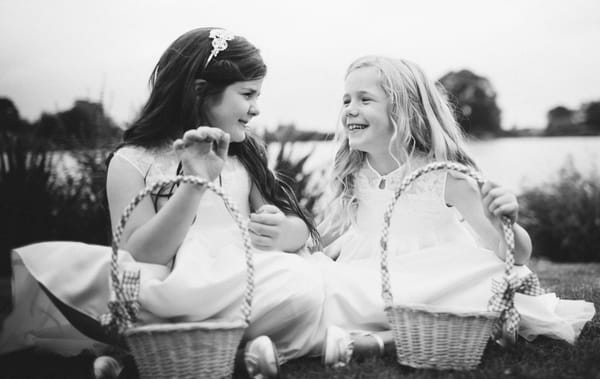 Flower girls sitting on grass