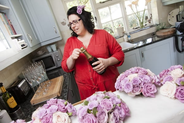 Bridesmaid opening Champagne