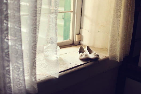 Bridal shoes on window ledge