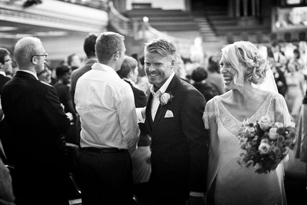 Bride and groom leave wedding ceremony