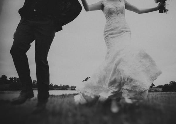 Bride and groom running at camera