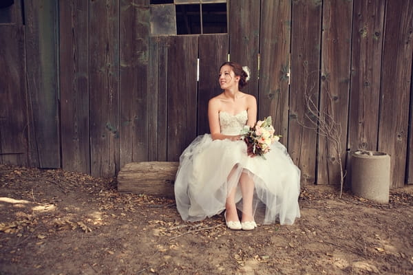 Bride sitting in barn