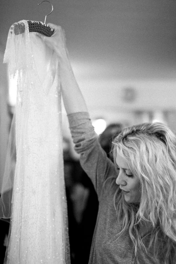 Bridesmaid holding up dress