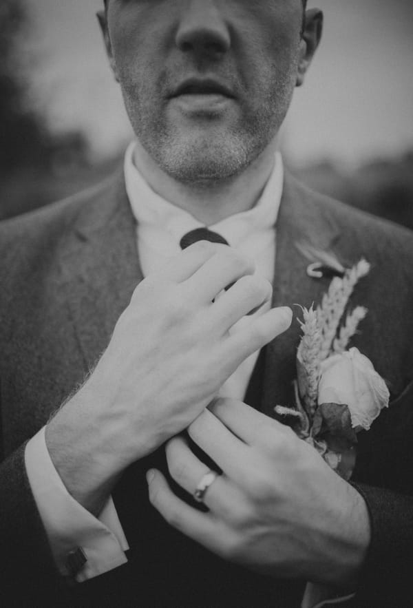 Groom adjusting tie