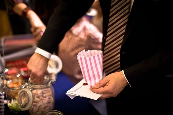 Man putting sweets in bag