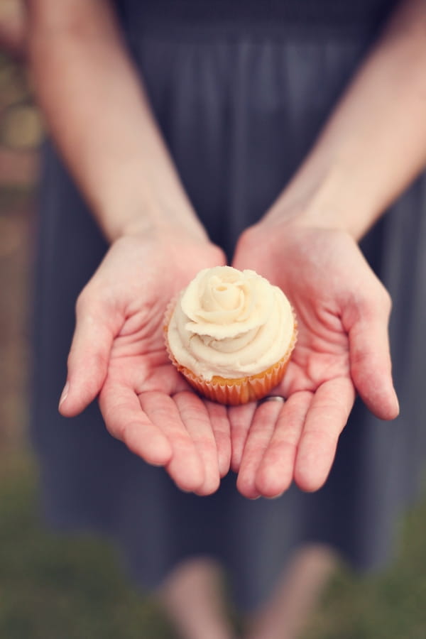 Hands holding cupcake