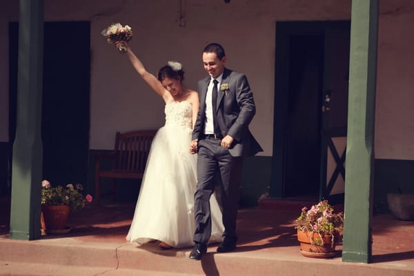 Bride and groom entering wedding reception