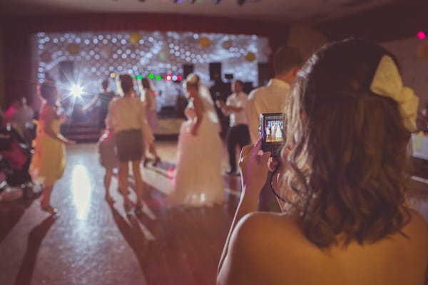 Taking picture of wedding guests dancing