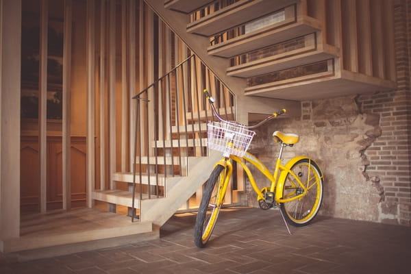 Yellow bicycle at bottom of stairs