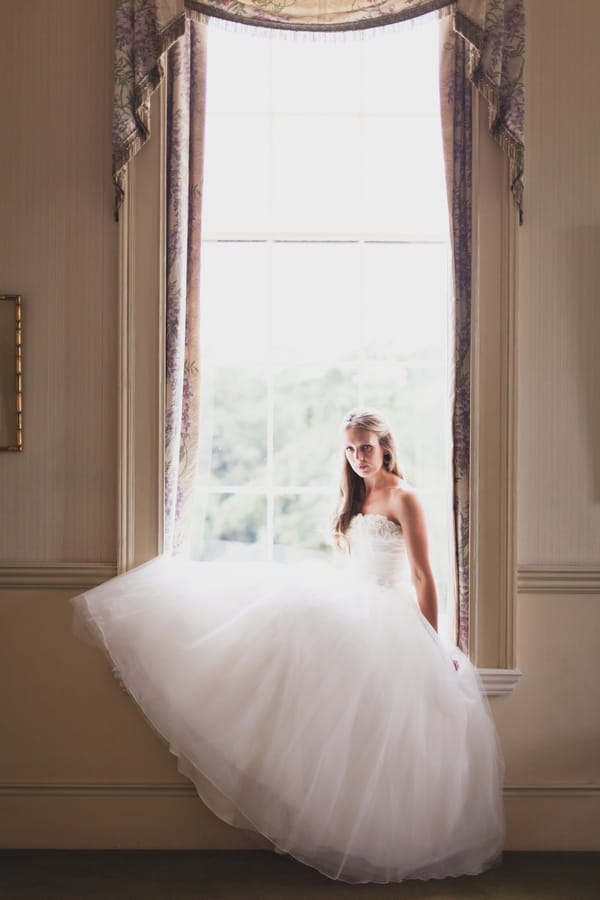 Bride sitting in window