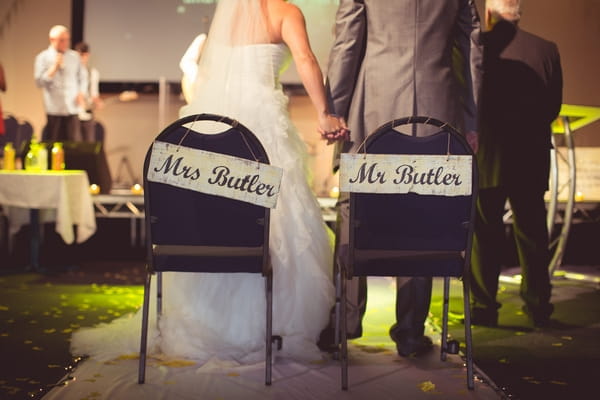 Bride and groom with Mr and Mrs chairs