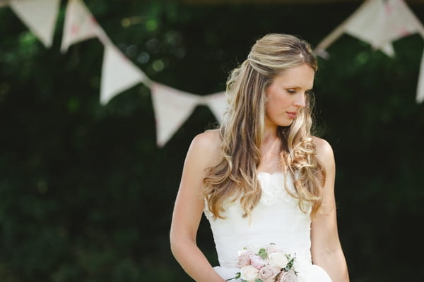 Bride standing in front of bunting