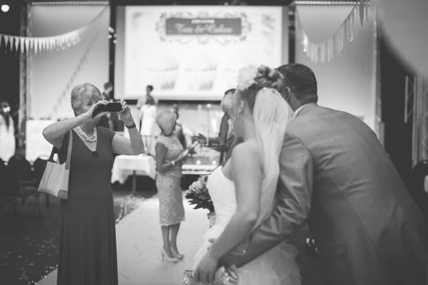 Guest taking picture of bride and groom