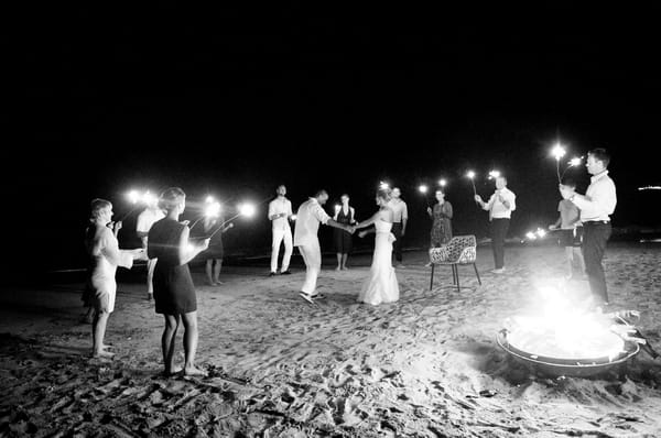 Bride and groom dance on beach