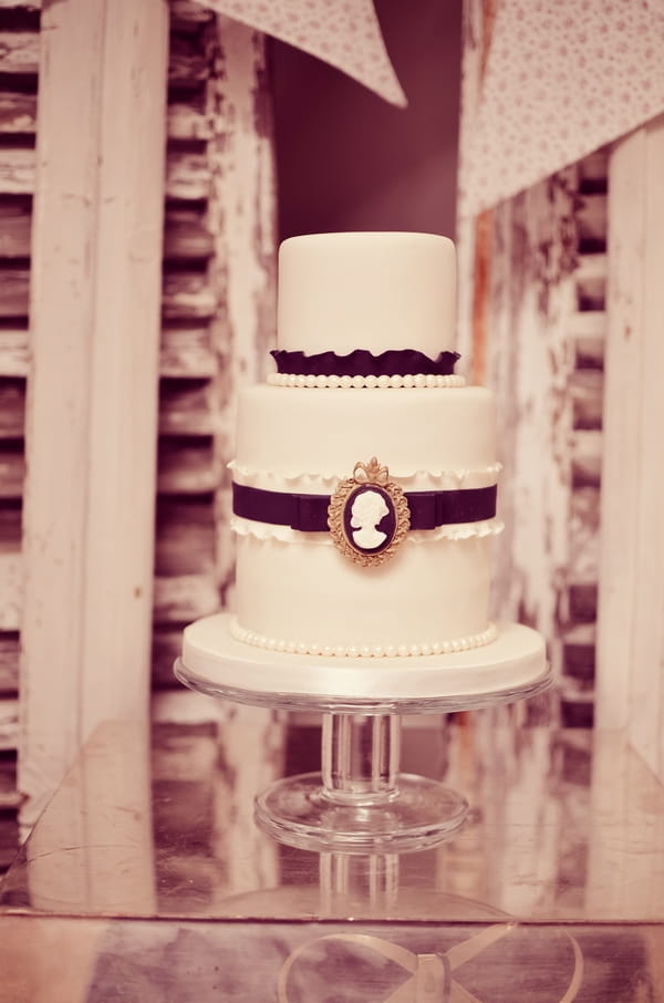 Tiered wedding cake with black ribbon