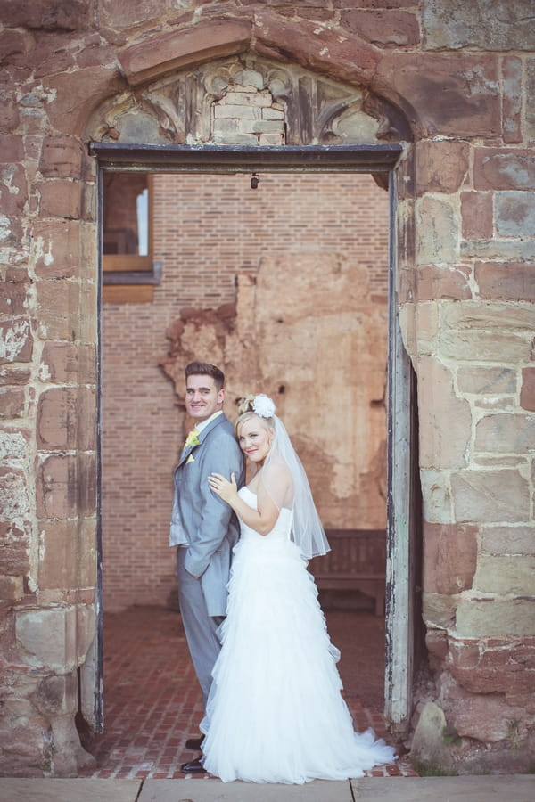 Bride and groom in doorway of Astley Castle