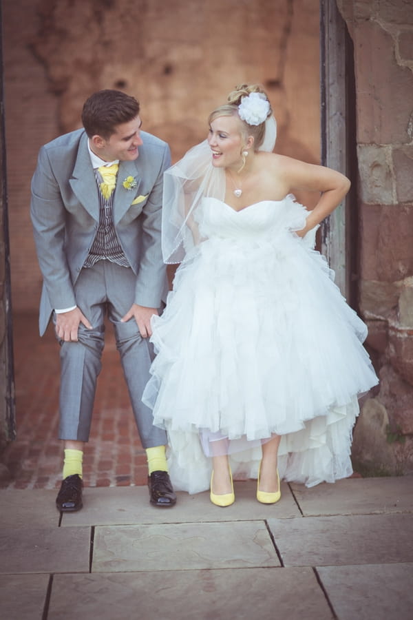 Bride and groom revealing yellow socks and shoes