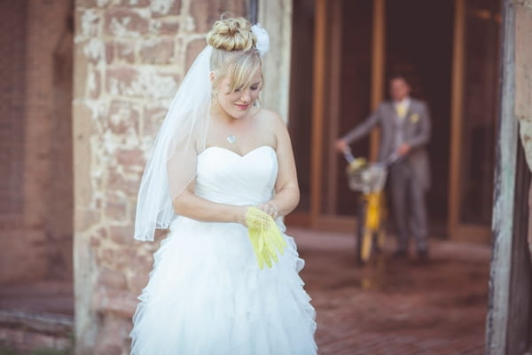 Bride putting on yellow gloves