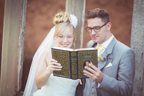 Bride and groom reading book