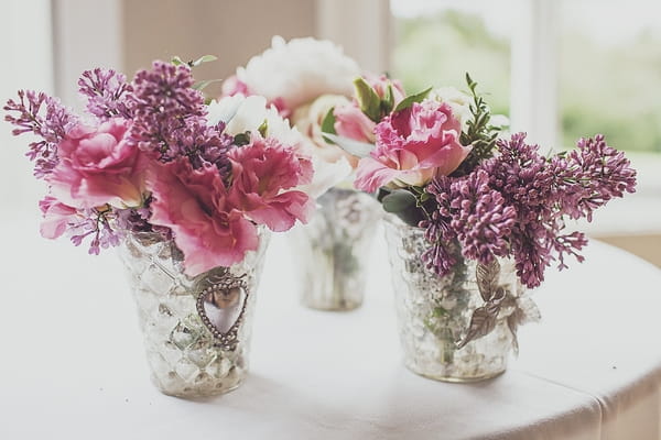 Small vases of wedding flowers