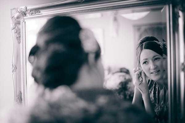 Bride putting on earrings