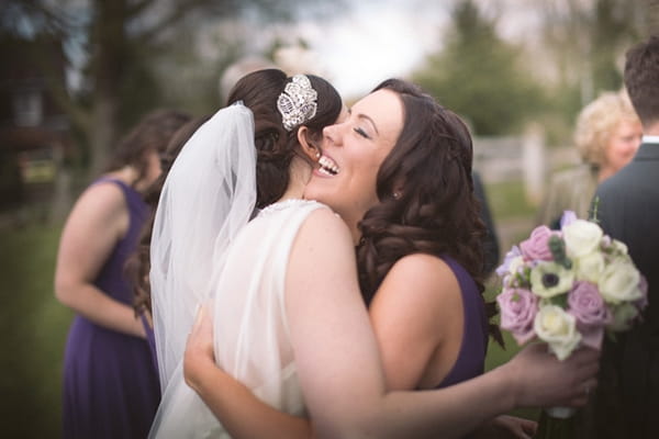 Bride hugging friend