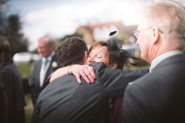 Groom hugging lady