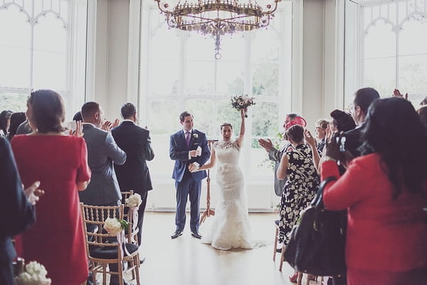 Bride waving bouquet in air