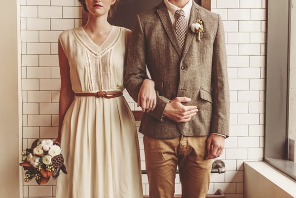 Vintage bride and groom with arms linked