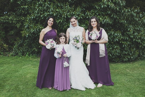 Bride and bridesmaids in purple dresses