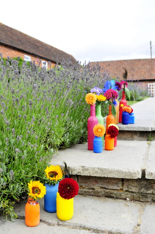 Coloured bottles of flowers