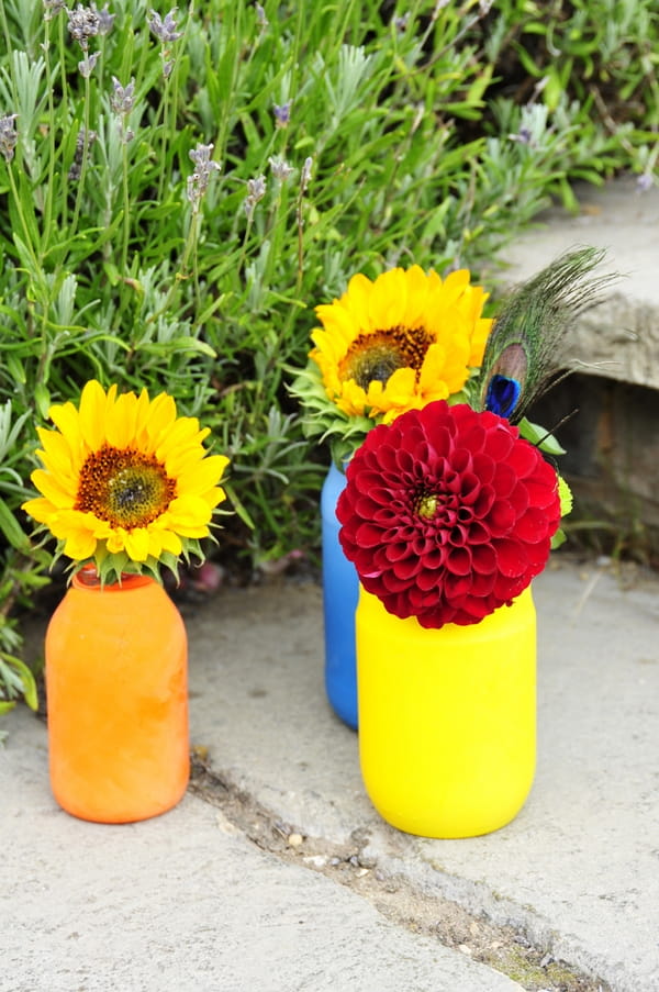 Coloured bottles of flowers