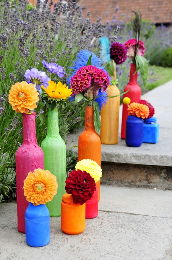 Coloured bottles of flowers