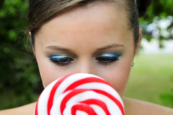 Bride's face behind lollipop