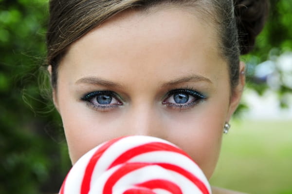 Bride's face behind lollipop