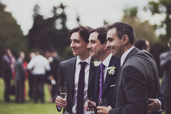 Groom standing with friends