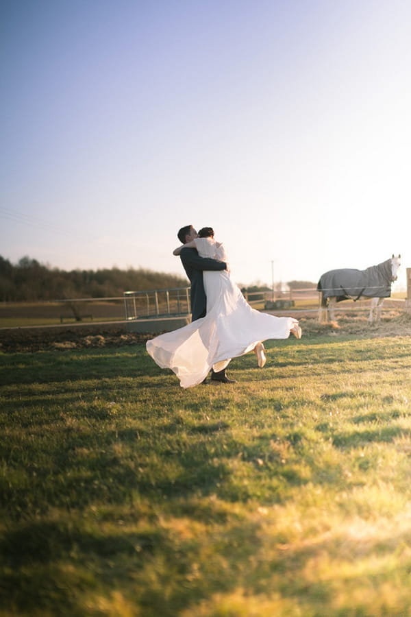 Groom lifting bride