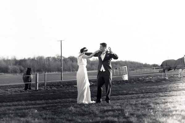 Bride and groom in field