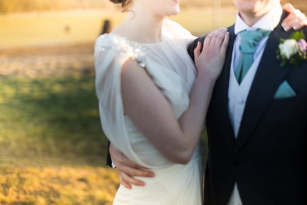 Bride's hand on groom's shoulder