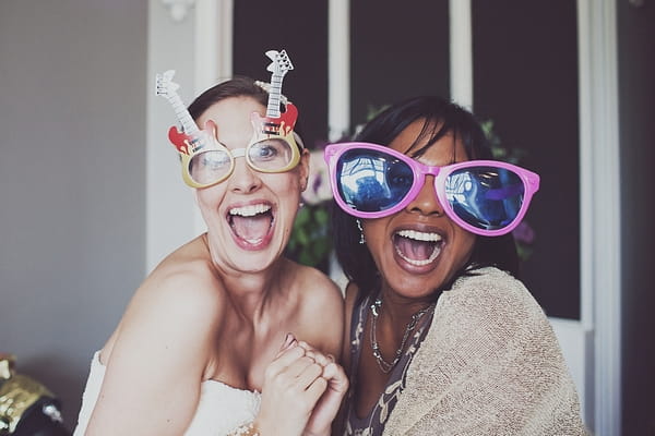 Wedding guests wearing funny glasses