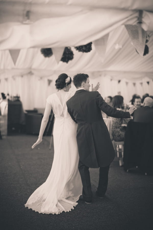 Bride and groom enter wedding breakfast