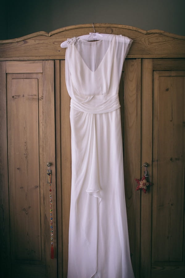 Wedding dress hanging on wardrobe