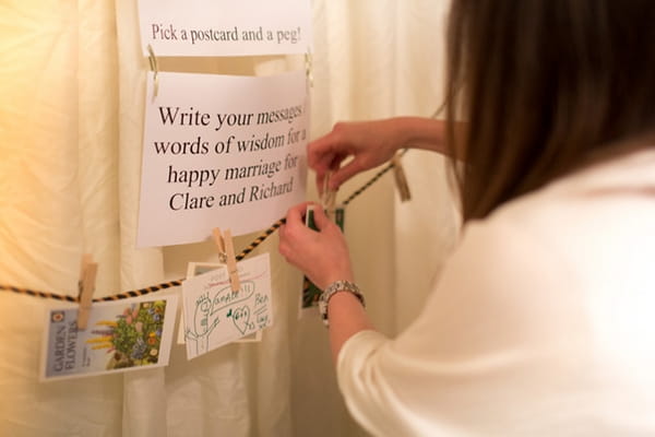 Guest pegging guest book message to washing line