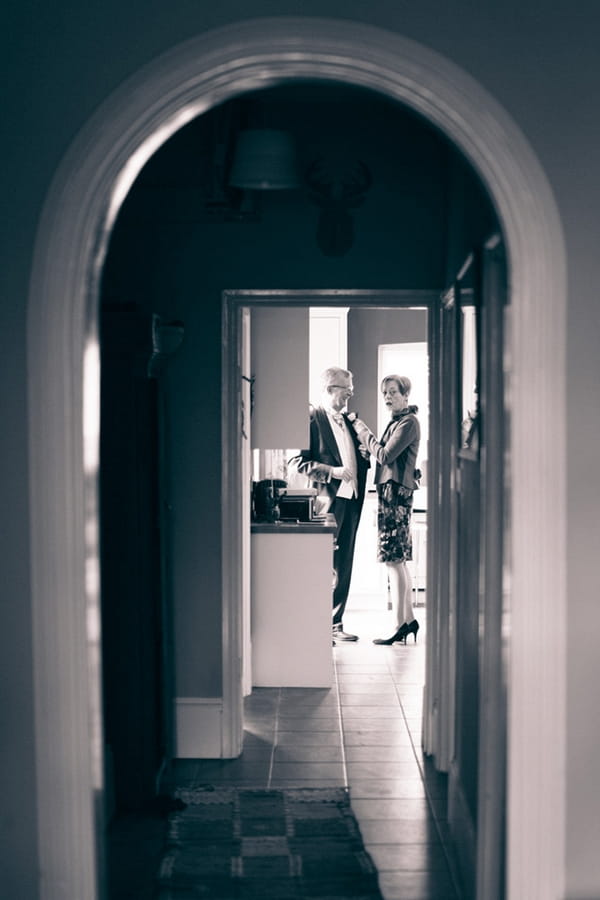 Lady helping man with buttonhole