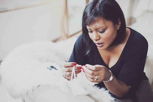 Lady making wedding dress adjustments