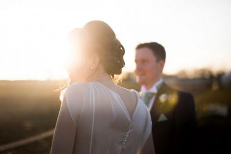 Bride and groom in hazy sunshire