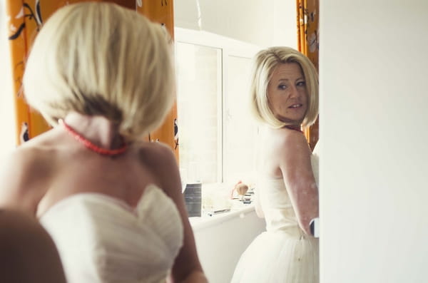 Bride looking in mirror