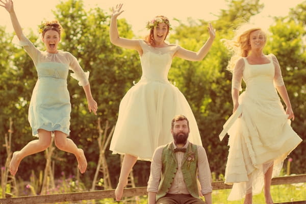 Vintage groom with brides jumping